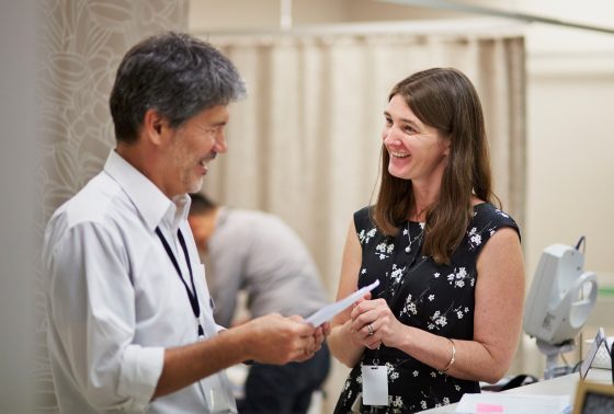 two doctors speaking in a clinical setting